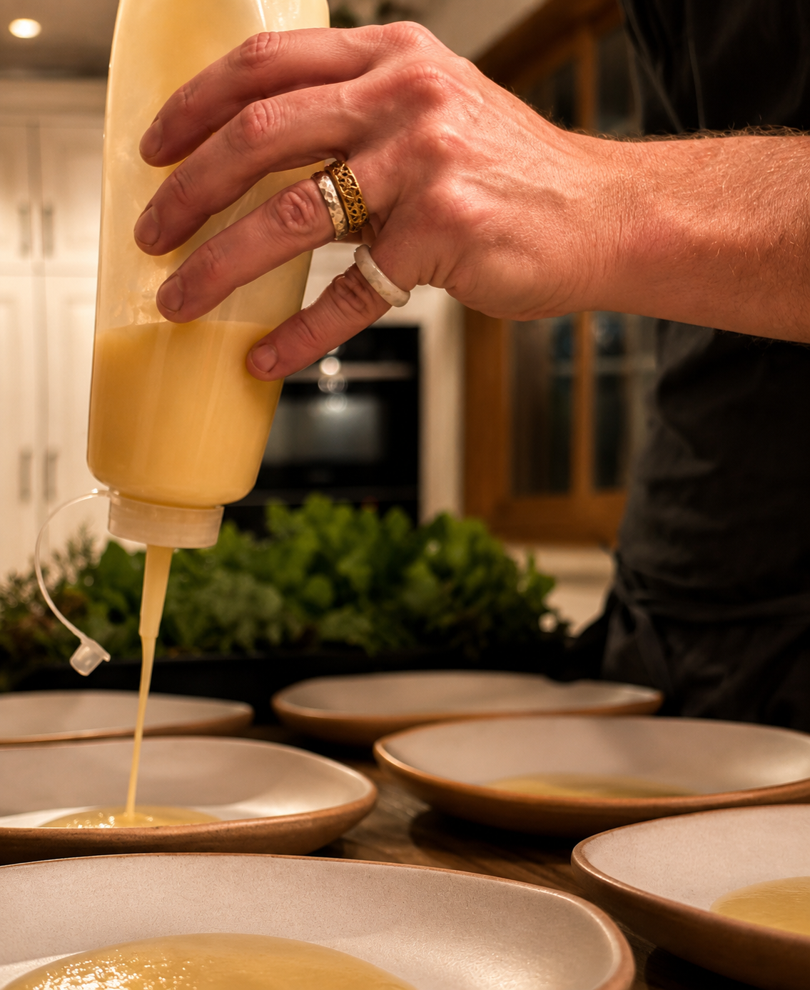 Squeezing vinaigrette over plates